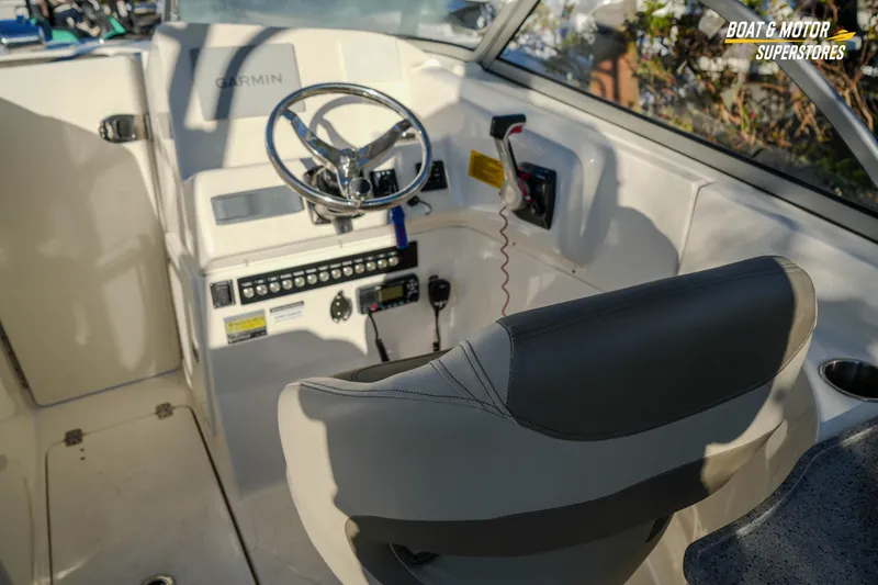 Slide: The Image of 2022 Key West 239 DFS boat cockpit with Garmin navigation and steering wheel. - 25