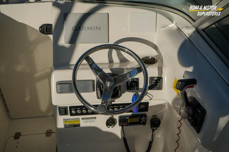 Slide: The Image of 2022 Key West 239 DFS boat dashboard with Garmin navigation system and steering wheel. - 26