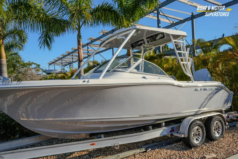 Slide: The Image of 2022 Key West 239 DFS boat on trailer, surrounded by palm trees. - 3