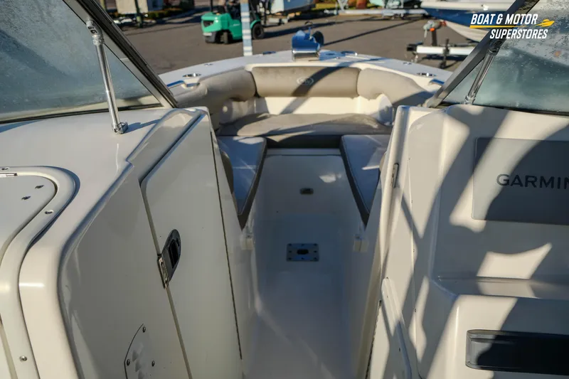 Slide: The Image of 2022 Key West 239 DFS boat interior with Garmin equipment, showcasing seating and storage. - 31