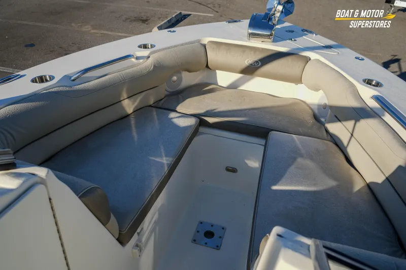 Slide: The Image of 2022 Key West 239 DFS boat interior with cushioned seating and cup holders. - 32