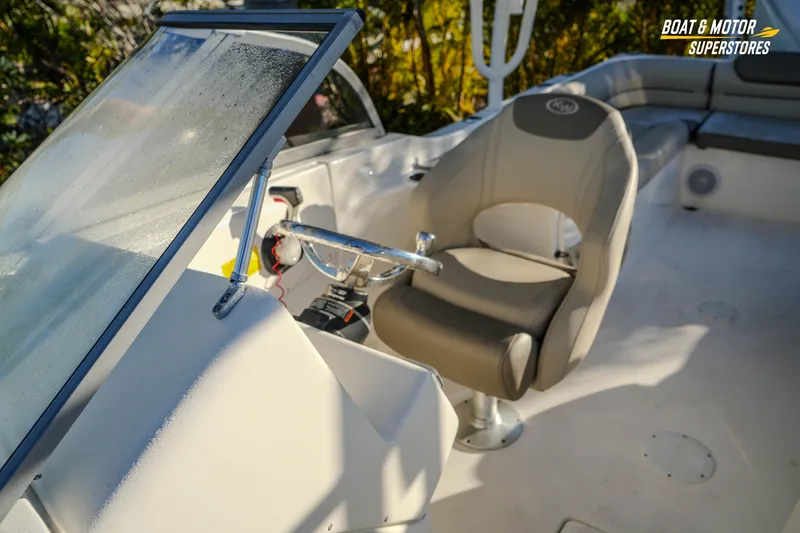 Slide: The Image of 2022 Key West 239 DFS boat interior with helm seat and windshield. - 34