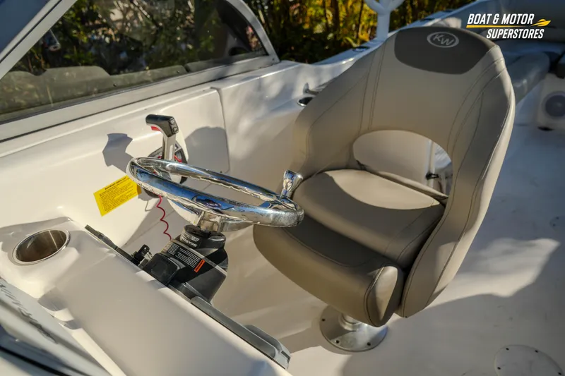Slide: The Image of 2022 Key West 239 DFS boat interior with steering wheel and captain's chair. - 35