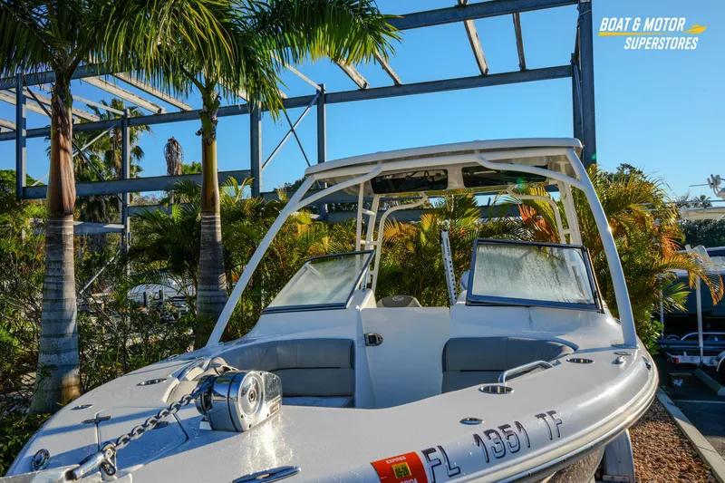 Slide: The Image of 2022 Key West 239 DFS boat displayed outdoors with palm trees in the background. - 8
