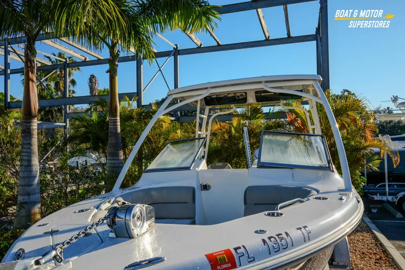 Slide: The Image of 2022 Key West 239 DFS boat in tropical setting, surrounded by palm trees. - 9