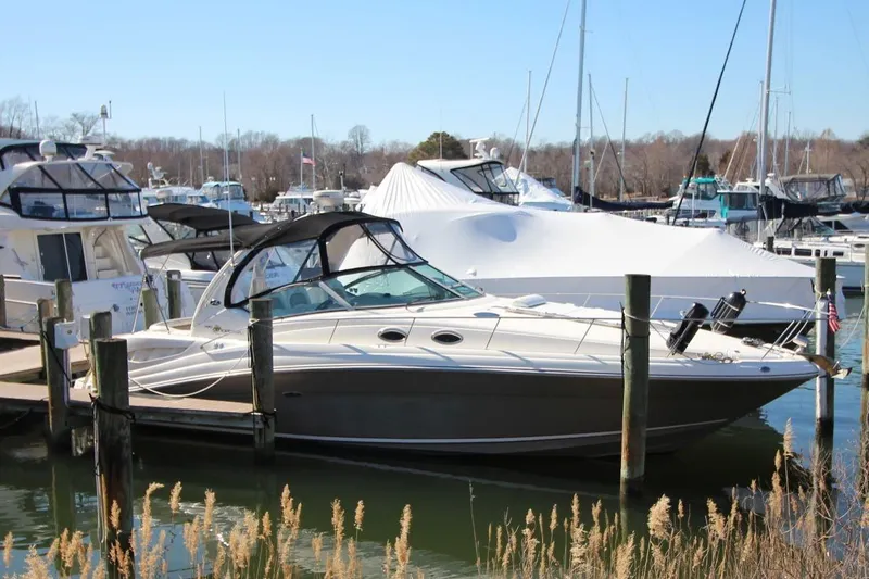 The Image of 2006 Sea Ray 340 Sundancer docked at a marina with other boats. - 0