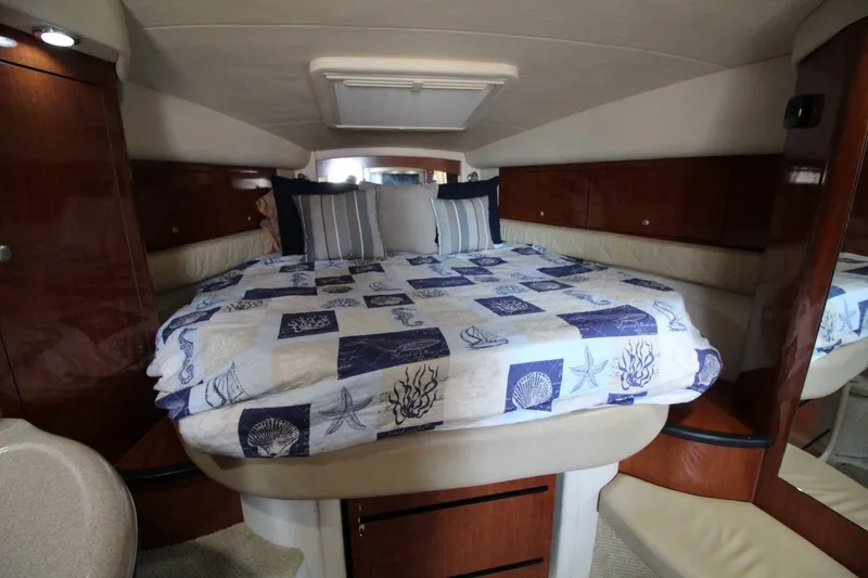 Slide: The Image of 2006 Sea Ray 340 Sundancer helm with Raymarine electronics and wood-accented steering wheel. - 12