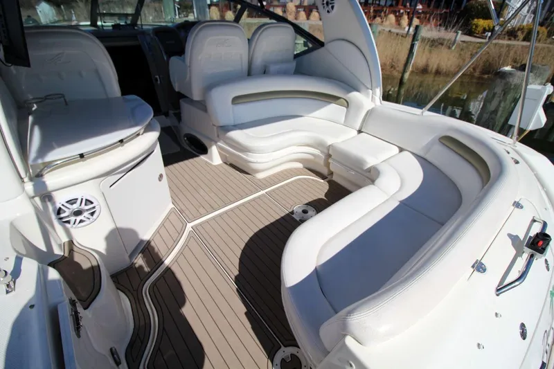 Slide: The Image of 2006 Sea Ray 340 Sundancer docked, featuring sleek design and black canopy. - 4