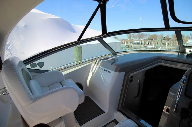 Slide: The Image of 2006 Sea Ray 340 Sundancer docked, aerial view, with black canopy and sleek white design. - 6