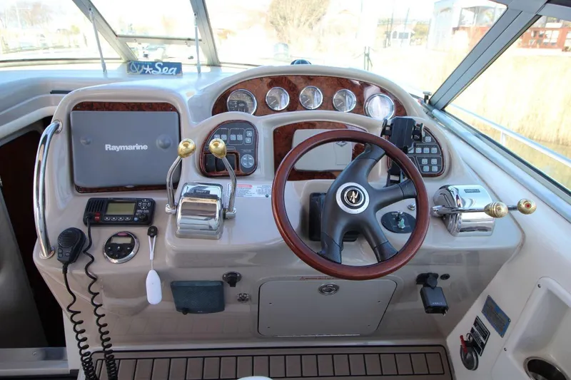 Slide: The Image of 2006 Sea Ray 340 Sundancer interior with white seating and wood-style flooring. - 8