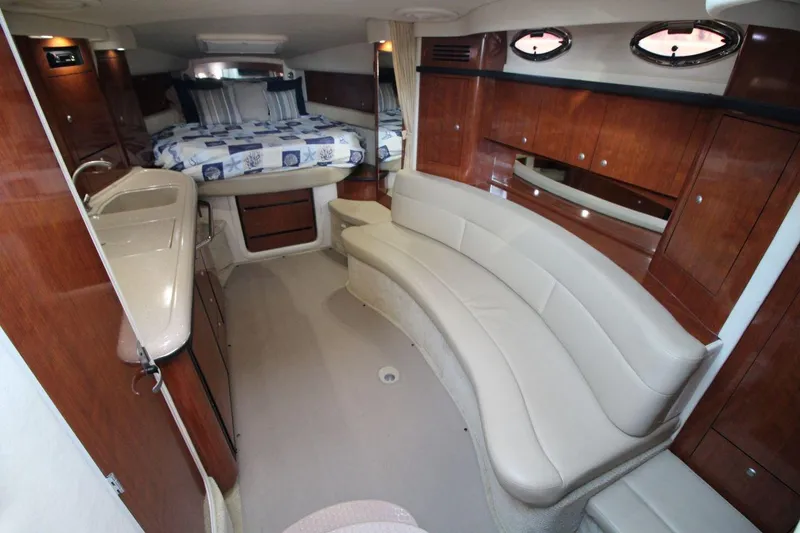 Slide: The Image of 2006 Sea Ray 340 Sundancer interior with white seating and modern amenities. - 9