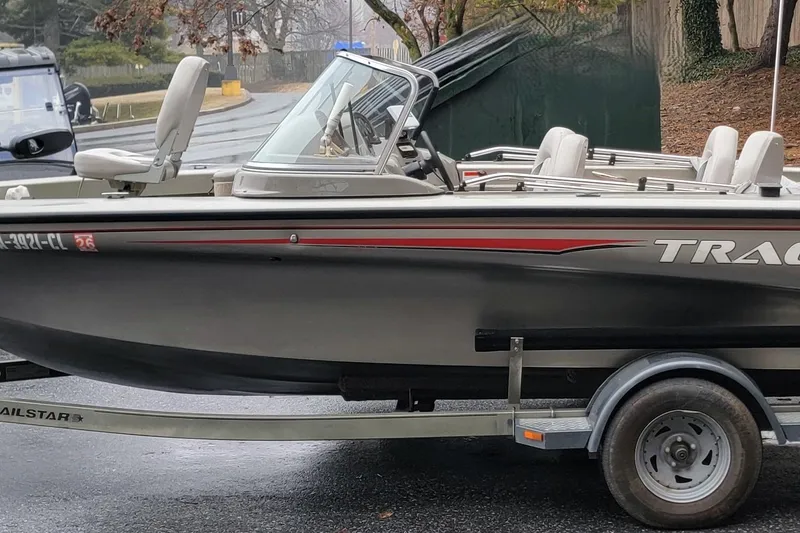 Slide: The Image of 2002 Tracker Tundra 18 WT boat on trailer, parked outdoors. - 12