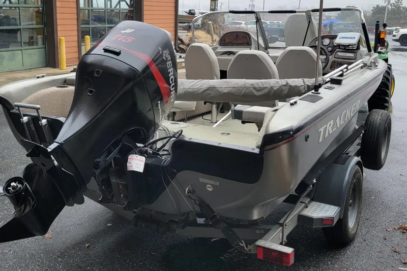 Slide: The Image of 2002 Tracker Tundra 18 WT boat with Mercury outboard motor on trailer. - 2