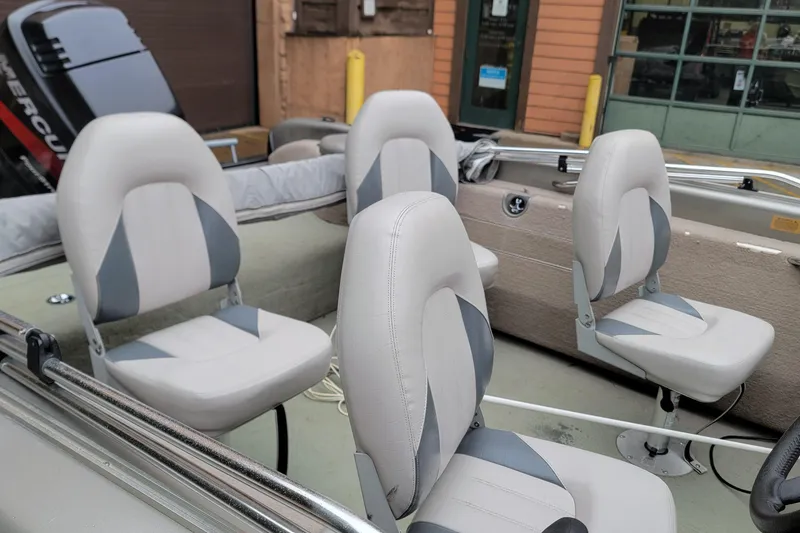 Slide: The Image of 2002 Tracker Tundra 18 WT boat interior with gray and white seating. - 4