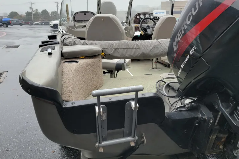 Slide: The Image of 2002 Tracker Tundra 18 WT boat with Mercury FourStroke EFI engine, parked on wet pavement. - 7