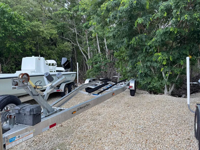 Slide: The Image of 2021 Yellowfin 26 Hybrid boat on trailer, surrounded by lush greenery. - 38
