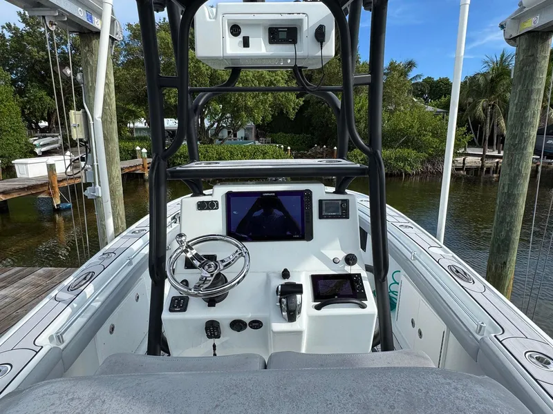 Slide: The Image of 2021 Yellowfin 26 Hybrid boat cockpit with modern navigation equipment and steering wheel. - 25