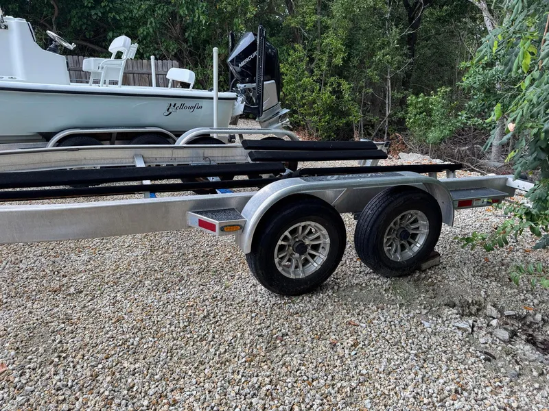 Slide: The Image of Trailer for 2021 Yellowfin 26 Hybrid boat on gravel driveway. - 40