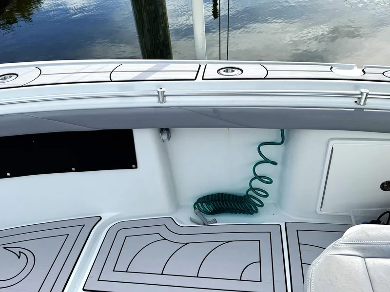 Slide: The Image of 2021 Yellowfin 26 Hybrid boat deck with coiled hose and sleek design. - 16