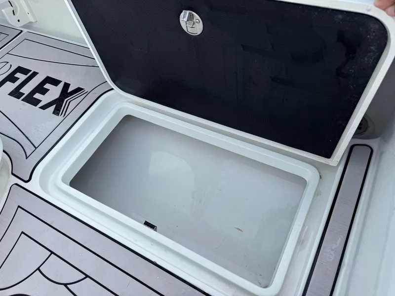 Slide: The Image of Open storage compartment on 2021 Yellowfin 26 Hybrid boat deck. - 31