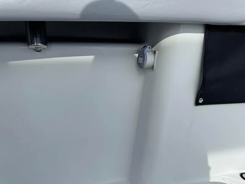 Slide: The Image of 2021 Yellowfin 26 Hybrid boat interior detail with plug socket and black fabric panel. - 20