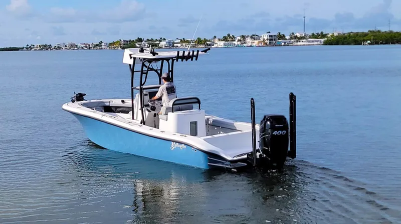 Slide: The Image of 2021 Yellowfin 26 Hybrid boat cruising on calm waters. - 10