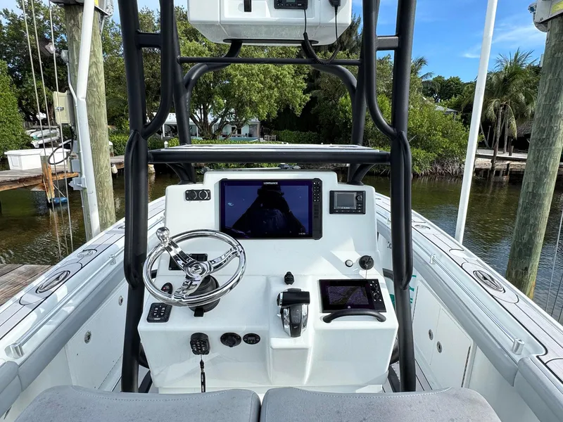 Slide: The Image of 2021 Yellowfin 26 Hybrid boat console with steering wheel and navigation screens. - 23