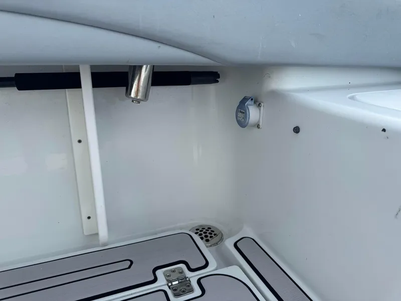 Slide: The Image of 2021 Yellowfin 26 Hybrid boat interior with rod holder and deck details. - 26
