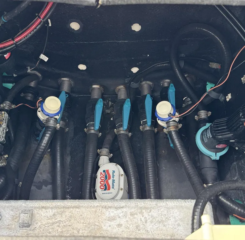 Slide: The Image of Bilge area of 2021 Yellowfin 26 Hybrid boat with pumps and hoses. - 33