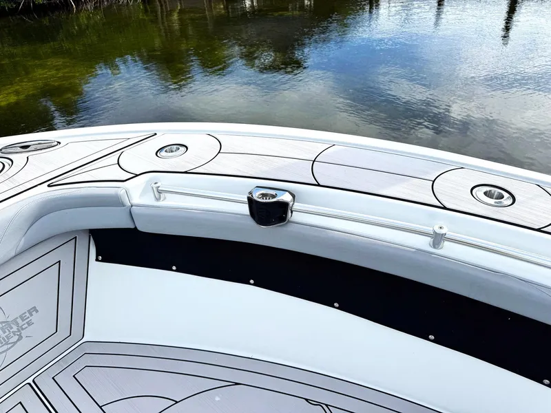 Slide: The Image of 2021 Yellowfin 26 Hybrid boat deck with sleek design on calm water. - 15
