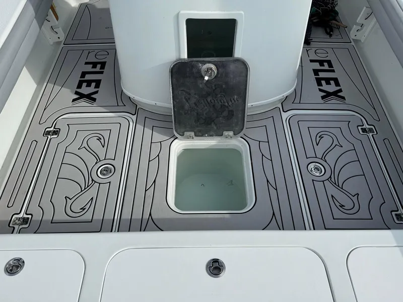 Slide: The Image of 2021 Yellowfin 26 Hybrid boat deck with Reflex flooring and open hatch. - 30