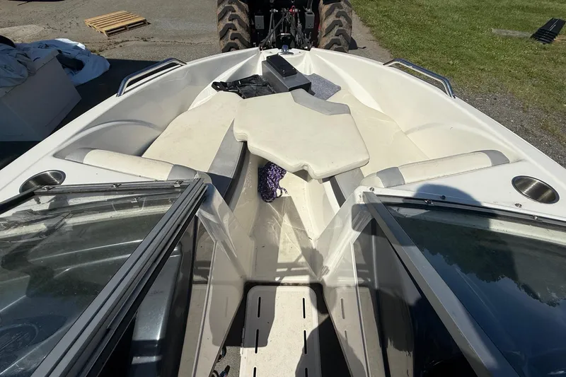 Slide: The Image of 2014 Larson LX 160S OB boat interior with open bow seating and windshield. - 12