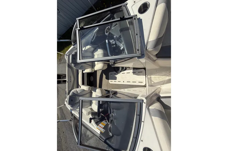 Slide: The Image of 2014 Larson LX 160S OB boat interior with open windshield and seating. - 13