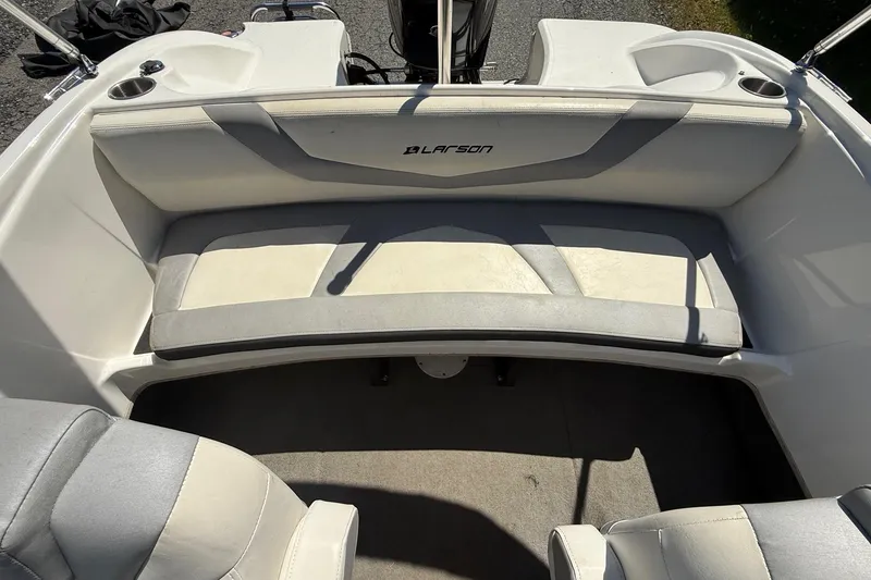Slide: The Image of 2014 Larson LX 160S OB boat interior with cushioned seating and cup holders. - 15