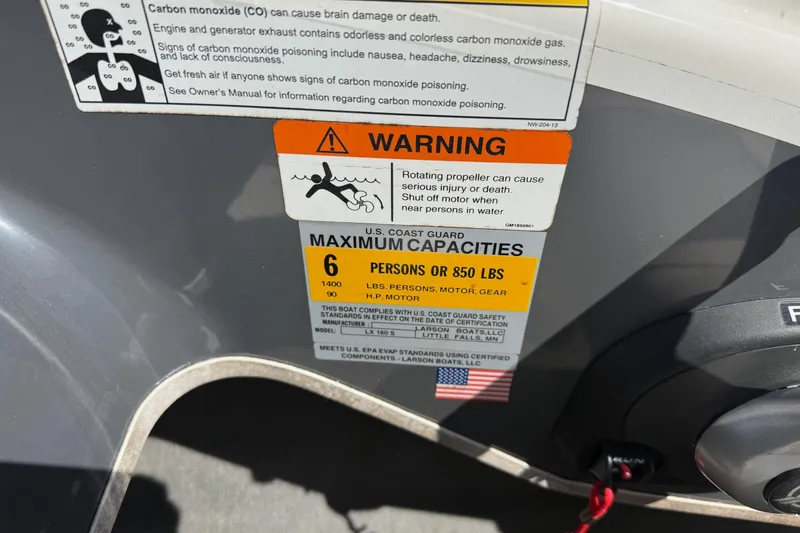 Slide: The Image of Warning and capacity labels on a 2014 Larson LX 160S OB boat. - 19