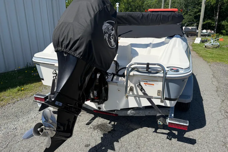 Slide: The Image of 2014 Larson LX 160S OB boat with covered outboard motor on trailer. - 2