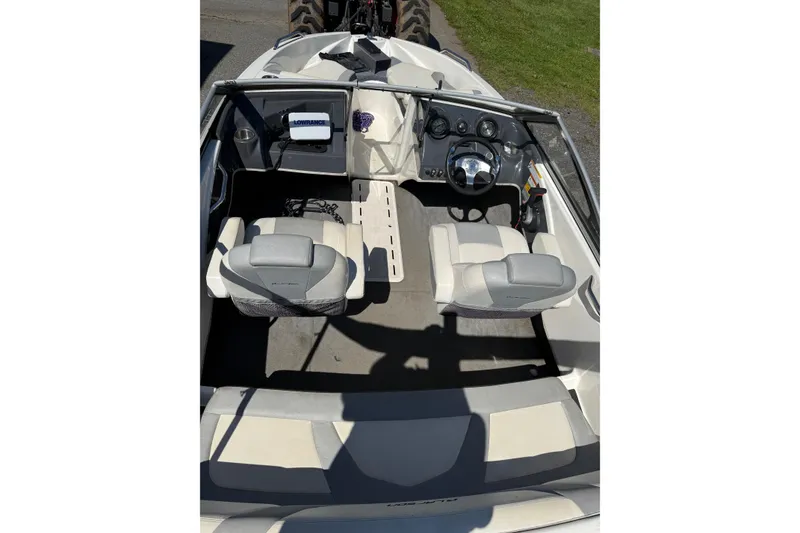Slide: The Image of 2014 Larson LX 160S OB boat interior with steering wheel and seating. - 20