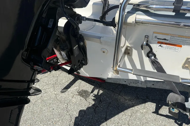 Slide: The Image of 2014 Larson LX 160S OB boat engine and rear view, showing motor and ladder details. - 26