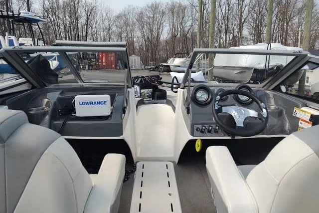 Slide: The Image of 2014 Larson LX 160S OB boat interior with steering wheel and Lowrance equipment. - 3