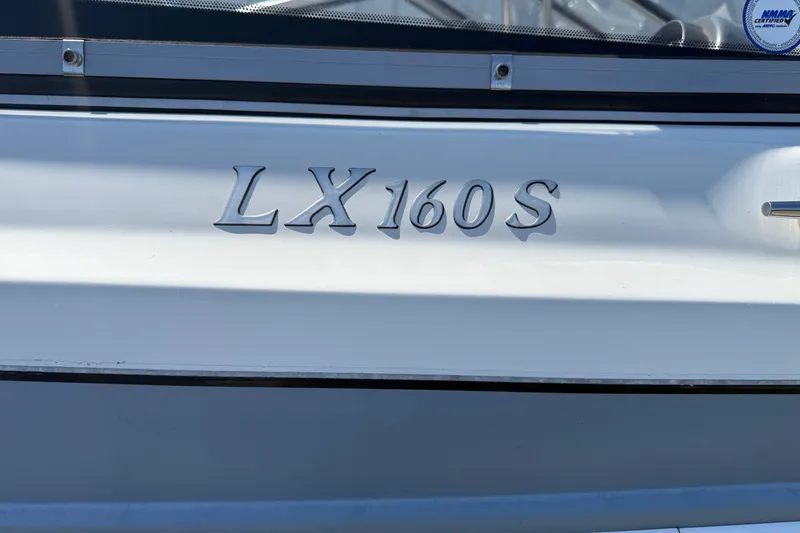 Slide: The Image of 2014 Larson LX 160S OB boat model nameplate on white hull. - 30