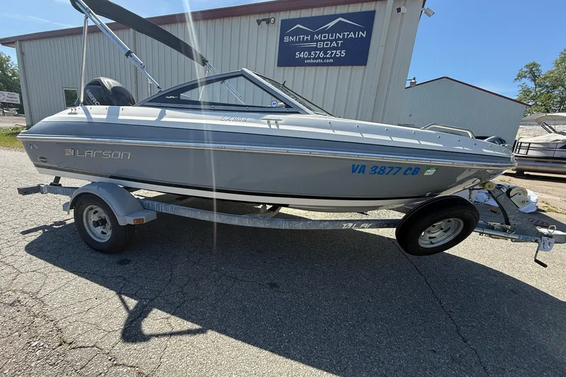 Slide: The Image of 2014 Larson LX 160S OB boat on trailer outside Smith Mountain Boat shop. - 31