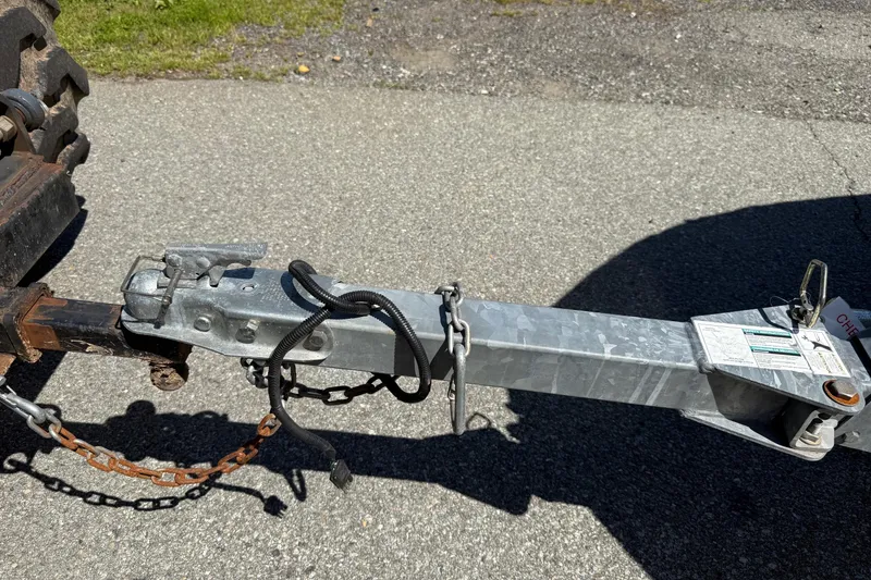 Slide: The Image of Trailer hitch of a 2014 Larson LX 160S OB on a paved surface. - 34
