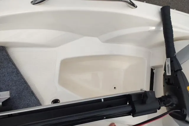 Slide: The Image of 2014 Larson LX 160S OB boat interior with steering mechanism and seating area. - 6
