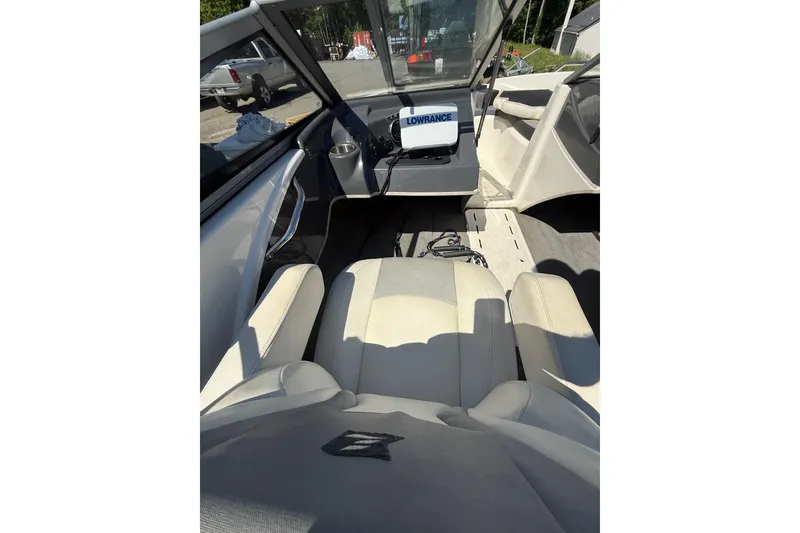 Slide: The Image of Interior view of 2014 Larson LX 160S OB boat with beige seating and navigation equipment. - 8