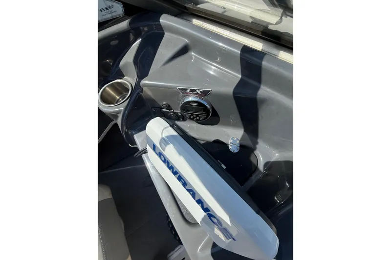 Slide: The Image of 2014 Larson LX 160S OB boat dashboard with Lowrance equipment and cup holder. - 9