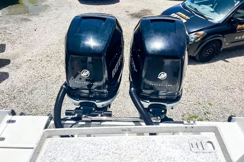 Slide: The Image of Twin Mercury outboard engines on a 2000 Boston Whaler 26 Outrage boat. - 4