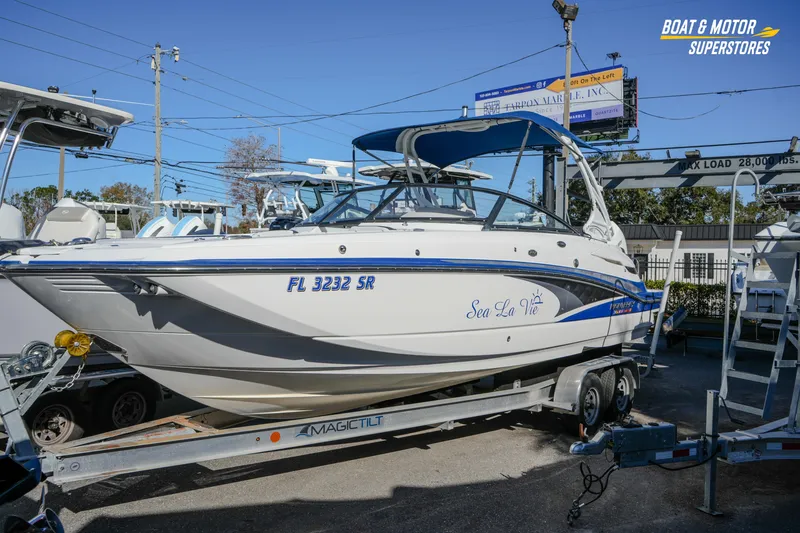 The Image of 2020 Monterey M-65 boat on trailer at dealership, featuring "Sea La Vie" name. - 1