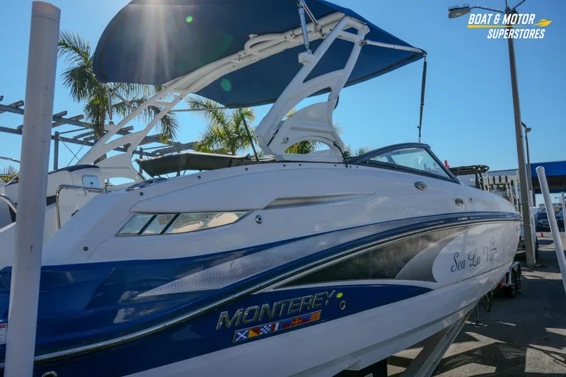 Slide: The Image of 2020 Monterey M-65 boat with blue and white design at a dealership. - 12