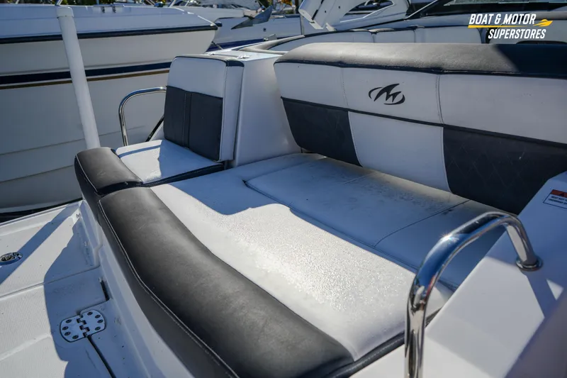 Slide: The Image of 2020 Monterey M-65 boat seating with black and white upholstery, featuring logo detail. - 17