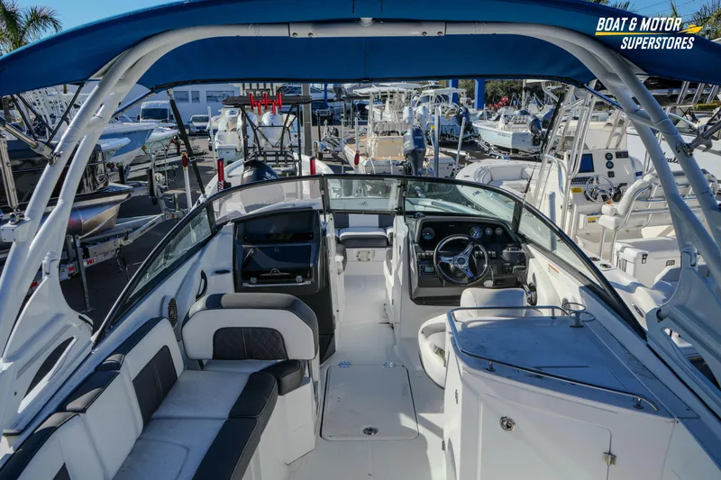 Slide: The Image of 2020 Monterey M-65 boat interior with seating and steering wheel at a dealership. - 19